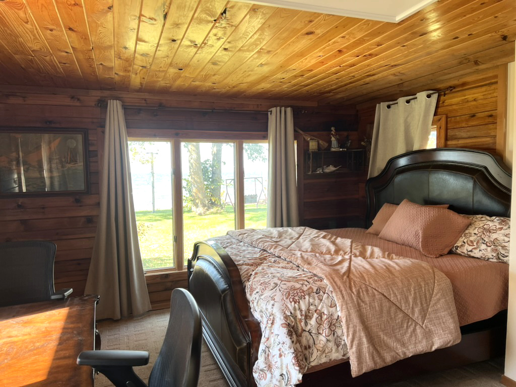 Rustic Lake Home bedroom with direct lake view at Wilderness Beach Resort